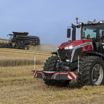 Traktor Massey Ferguson MF 9S na poli v pozadí s kombajnem